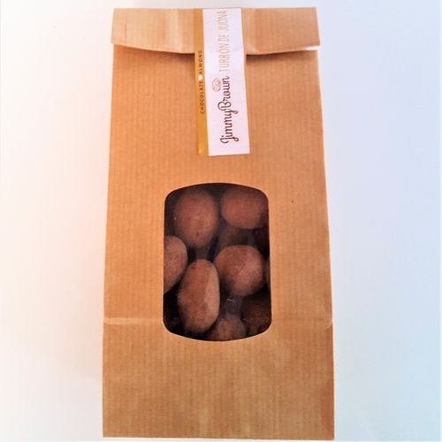 Almond covered by Jijona´s Nougat flavored chocolate and cocoa. Presented in 225g karft bag